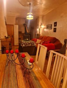 a living room with a couch and a table with red candles at Entre Vistas in Zahara de la Sierra