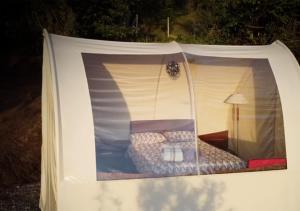 a white tent with a bed in it at Refugios de Alta Güita in Suesca