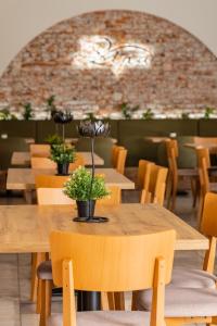 a dining room with wooden tables and chairs at Hotel Lipa in Bojnice