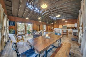 a living room with a wooden table and chairs at Bonners Ferry Cabin with Wraparound Deck and Views! in Bonners Ferry