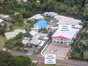an aerial view of a village with houses at Samoa Business Apartments in Apia