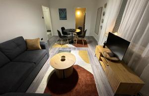 a living room with a couch and a table at Arctic Apartment Rovaniemi in Rovaniemi