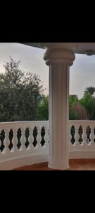a white fence with a white column in front of a window at Soliman Villa in Luxor