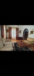 a living room with a couch and a coffee table at Soliman Villa in Luxor