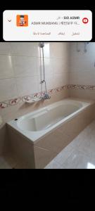 a bathroom with a bath tub in a room at Soliman Villa in Luxor