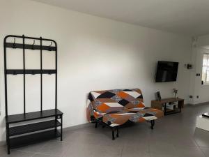 a living room with a couch and a tv at Douai à proximité in Flers-en-Escribeus