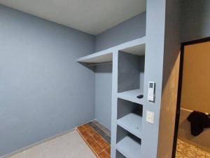 a walk in closet with shelves in a room at Casa Ciruelos Relax Confort and Relax in Ciudad Madero
