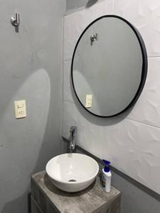 a bathroom with a white sink and a mirror at Casa Ciruelos Relax Confort and Relax in Ciudad Madero +8 photos