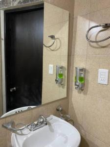 a bathroom with a sink and a mirror at Casa Ciruelos Relax Confort and Relax in Ciudad Madero