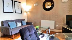 a living room with a couch and a glass table at Cool new Notting Hill apt - 2 mins to Portobello in London