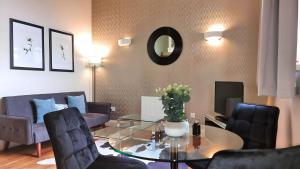 a living room with a glass table and chairs at Cool new Notting Hill apt - 2 mins to Portobello in London