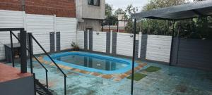 a swimming pool in a backyard with a fence at Niño in Posadas