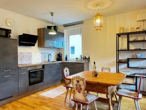 a kitchen with a wooden table and a dining room at Ferienwohnung im Sonnendorf Öblarn in Öblarn