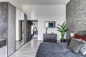 a bedroom with a bed and a brick wall at 1000 Suites in Naples