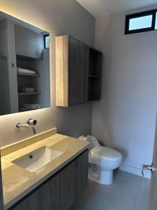 a bathroom with a sink and a toilet at Luxury Studio con Vista in Cali