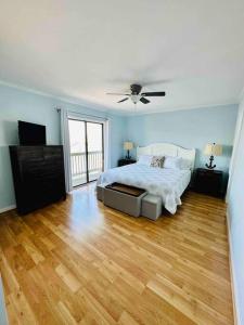 a bedroom with a bed and a ceiling fan at Living the Dream on the beach! in Carolina Beach