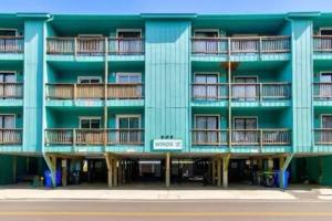 un edificio azul con balcones en un lateral en Living the Dream on the beach! en Carolina Beach