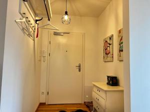 a hallway with a door and a dresser in a room at Ferienwohnung im Sonnendorf Öblarn in Öblarn