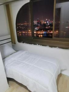 a bed in a room with a large window at Cloud9 Premium Hostel in Dubai