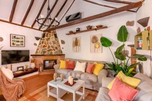 a living room with a couch and a fireplace at Las Casas de la Rueda - El Patio in Santa Lucía