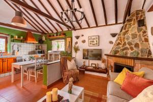 a living room with a couch and a fireplace at Las Casas de la Rueda - El Patio in Santa Lucía