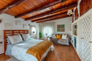 a bedroom with a bed and a couch in it at Las Casas de la Rueda - El Patio in Santa Lucía +27 photos