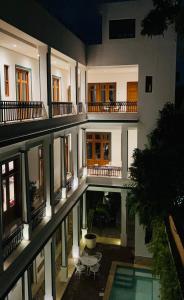 an external view of a building with a swimming pool at Boutique Hotel Casa Grande in Santo Domingo