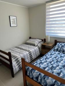 - une chambre avec 2 lits et une fenêtre dans l'établissement Condominio Lagunamar, Las Cruces, à San Antonio