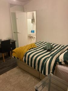 1 dormitorio con 1 cama con edredón blanco y negro en Wendover St, High Wycombe, en Buckinghamshire