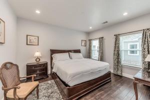 a bedroom with a bed and a desk and a chair at Stylish 3 BDR House 5 miles to Downtown! in Houston