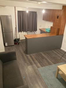 a room with a kitchen with a counter and a refrigerator at Wendover St, High Wycombe in Buckinghamshire