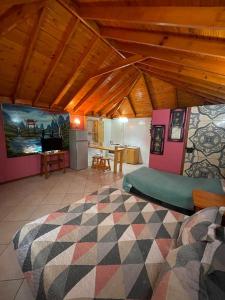 a large room with two beds and a kitchen at Cabañas Los Olmos in San José de Maipo