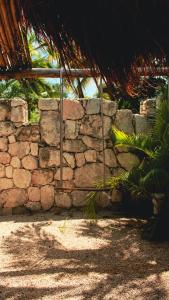 a stone wall next to a stone wall at Tortuga Bacalar in Bacalar