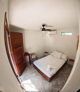 a bedroom with a bed and a ceiling fan at Tortuga Bacalar in Bacalar