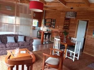 a living room with a couch and a table and chairs at Casa Ayuntún in Puerto Montt