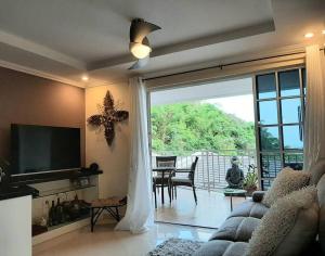 a living room with a couch and a sliding glass door at Viewscape Condo 3bedrooms in Port-of-Spain