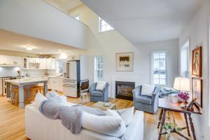 a living room with white furniture and a kitchen at Airy West Cape May Cottage Less Than 1 Mi to Beach! in Cape May