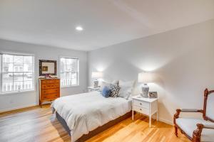 a white bedroom with a bed and a chair at Airy West Cape May Cottage Less Than 1 Mi to Beach! in Cape May