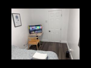 a bedroom with a bed and a desk with a computer at Stylist bedroom central of Baltimore in Baltimore +3 photos