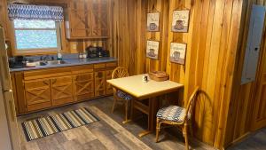 a kitchen with a small table and a sink at Getaway to a very private beautiful Cabin. in Kyles Ford