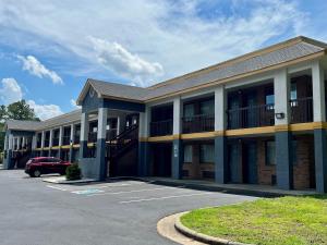 a building with a car parked in a parking lot at Econo Lodge in Sanford