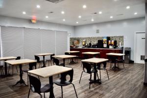 a room with desks and chairs and a counter at Econo Lodge in Sanford