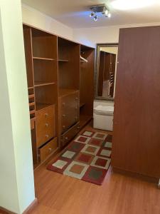 an empty room with wooden cabinets and a room with a mirror at Hotel Boutique Azhares in Copiapó