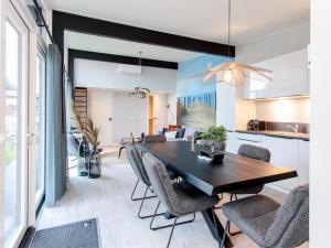 a dining room and kitchen with a table and chairs at Top-Nova Scotia in Voorthuizen