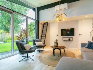 a living room with a couch and chairs and a tv at Top-Nova Scotia in Voorthuizen