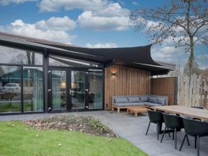 an outdoor patio with a couch and a table at Top-Nova Scotia in Voorthuizen