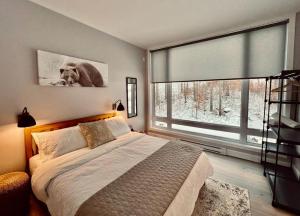 a bedroom with a large bed and a large window at The Golden View - Luxury Cottage in La Conception