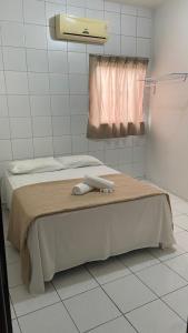 Łóżko lub łóżka w pokoju w obiekcie SÃO CRISTOVÃO HOTEL