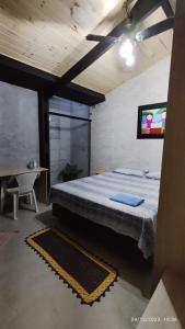 a bedroom with a bed and a tv on the wall at Hospedagem Em Santana de Parnaíba 67 in Santana de Parnaíba +6 photos