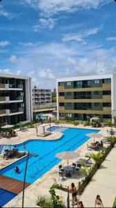 a large swimming pool in front of two buildings at Mana Beach Experience -02Garagens - Aloha 001 in Ipojuca